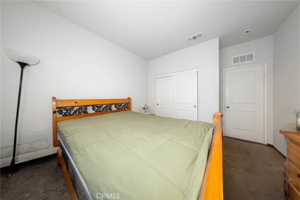 a spacious bedroom with a bed and a table