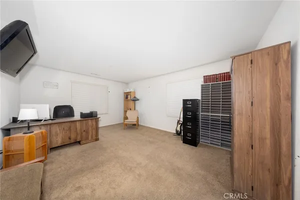 a view of an empty room with furniture and storage
