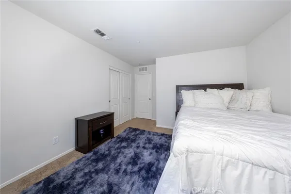 a bedroom with a bed and a television