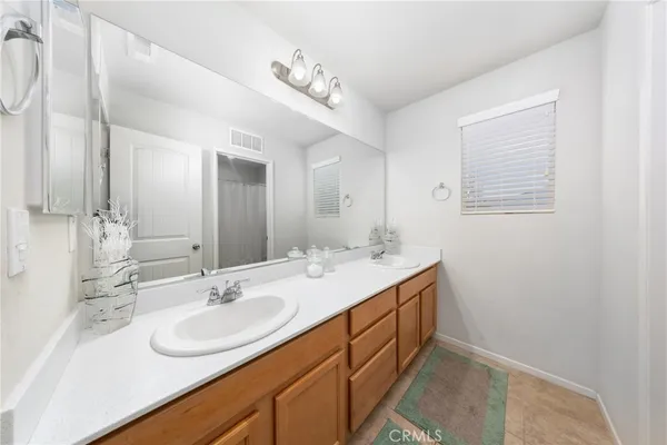 a bathroom with a sink double vanity and a mirror