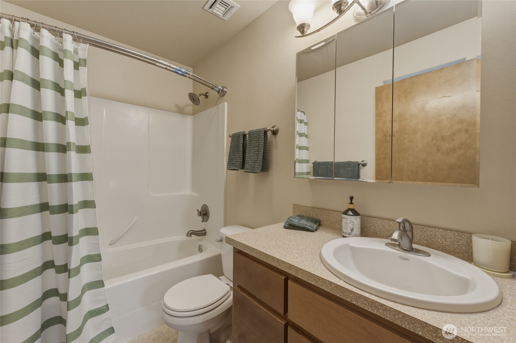 15 Southwest 13th Street College Place, WA 99324 - Photo 11 of 36 a bathroom with a granite countertop sink mirror toilet and bathtub