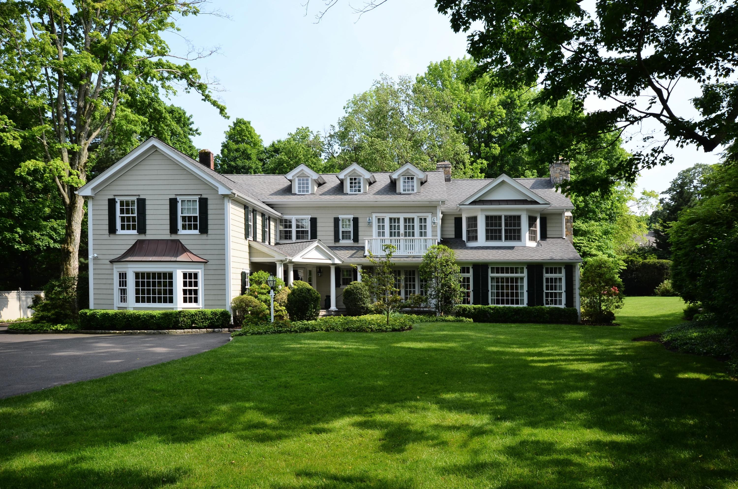 a front view of a house with a garden