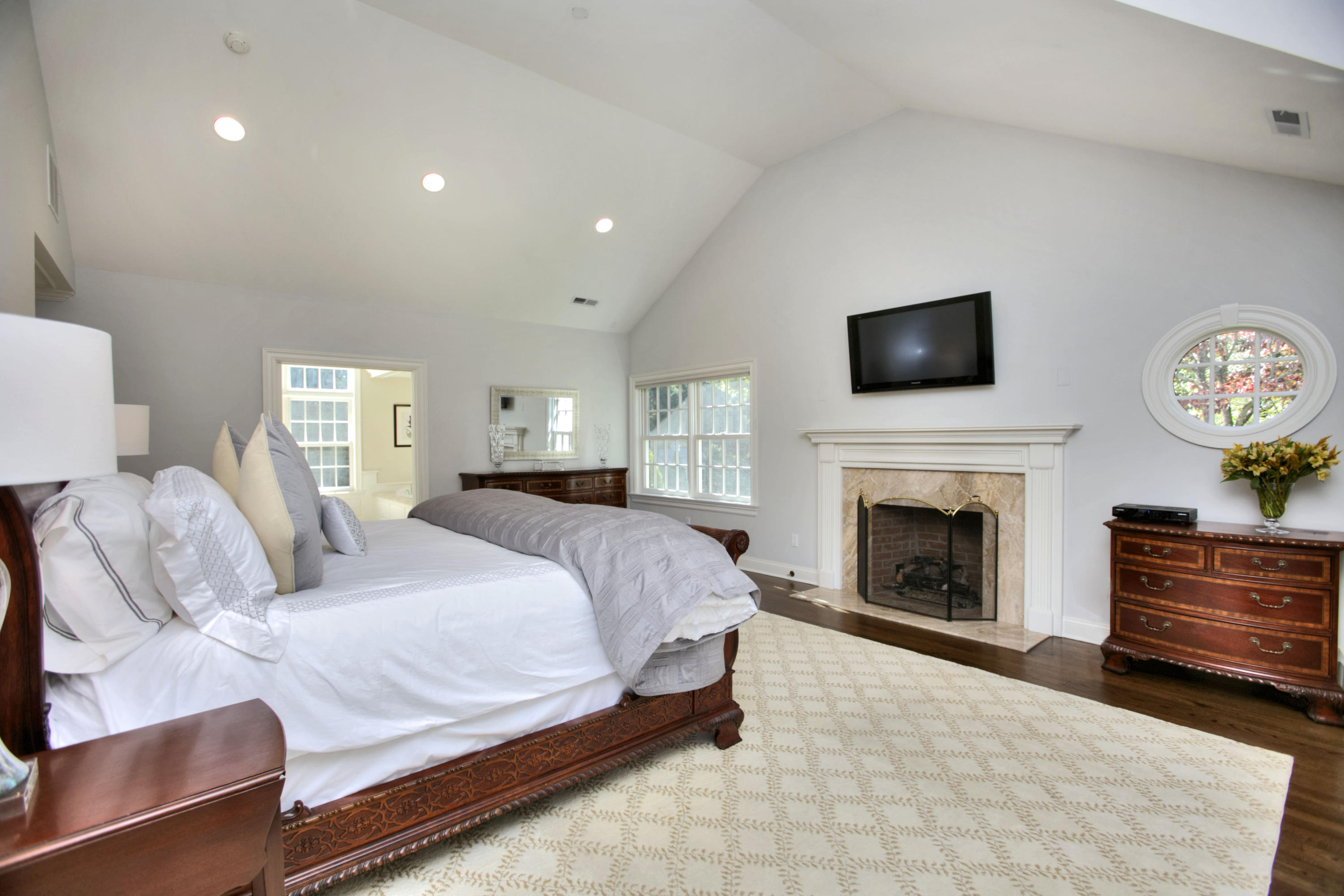 4 St Nicholas Road Darien, CT 06820 - Photo 10 of 15 a spacious bedroom with a bed and a flat screen tv