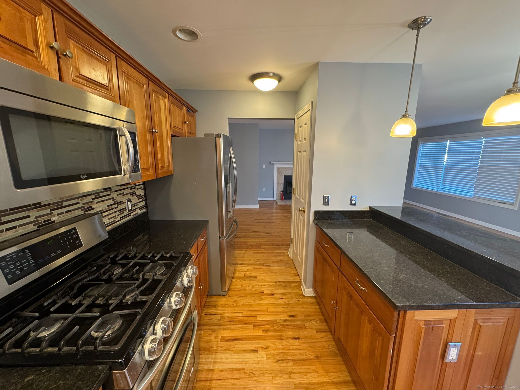59 Gilbert Lane Branford, CT 06405 - Photo 11 of 40 a kitchen with a stove and a wooden floor