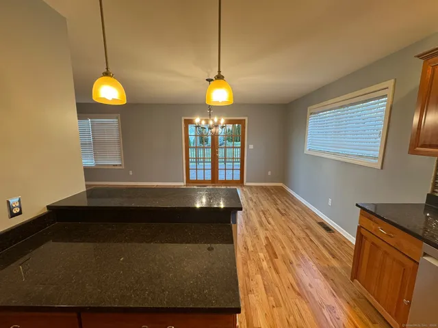 a view of a chandelier fan and wooden floor