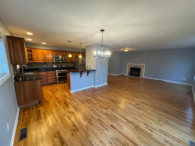 a view of kitchen with sink microwave and refrigerator