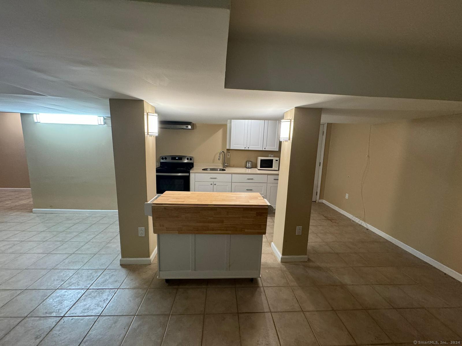 59 Gilbert Lane Branford, CT 06405 - Photo 35 of 40 a large kitchen with cabinets and stainless steel appliances