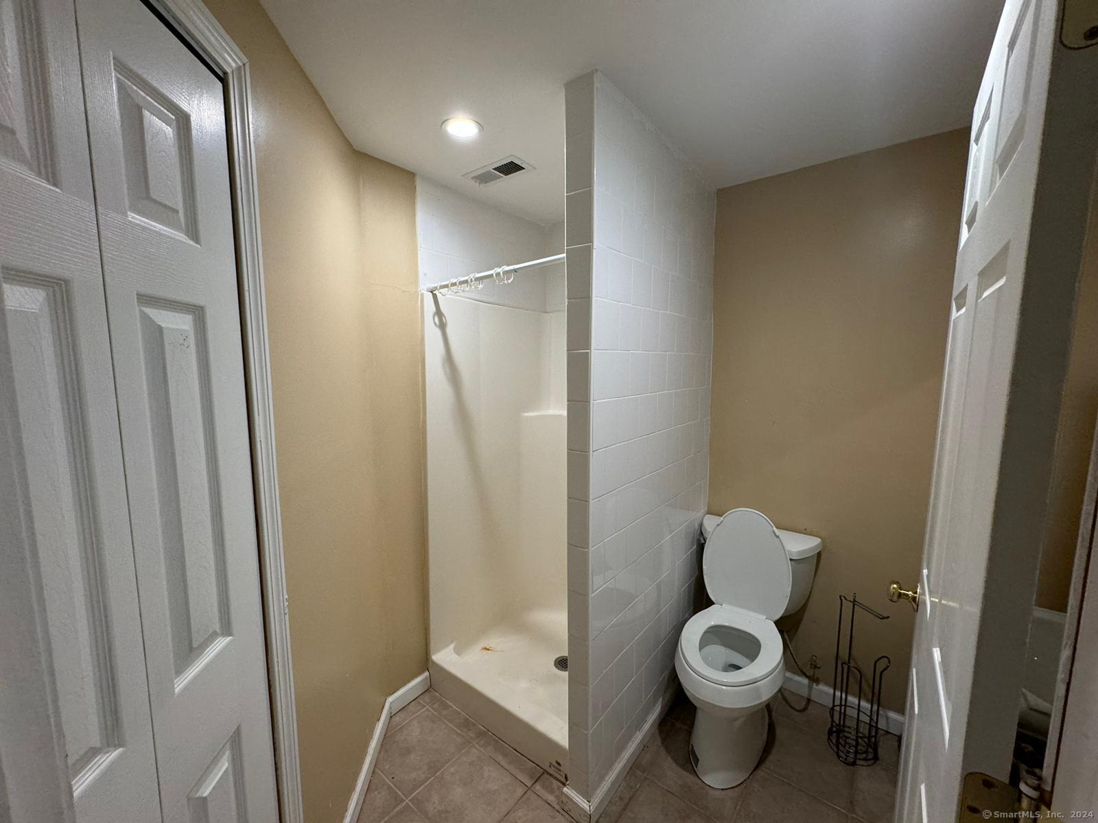 59 Gilbert Lane Branford, CT 06405 - Photo 38 of 40 a bathroom with a toilet and a shower