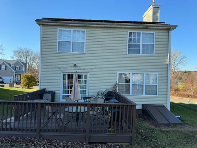 a front view of house with deck and yard
