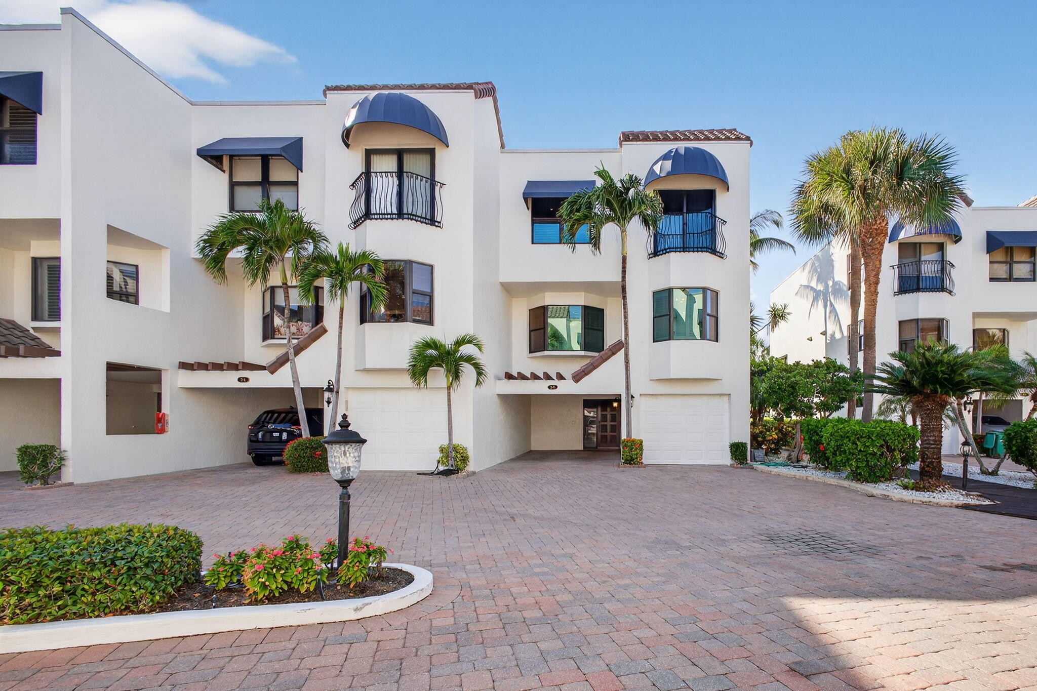 170 Celestial Way, Unit 35 Juno Beach, FL 33408 - Photo 2 of 53 a front view of a house with garden