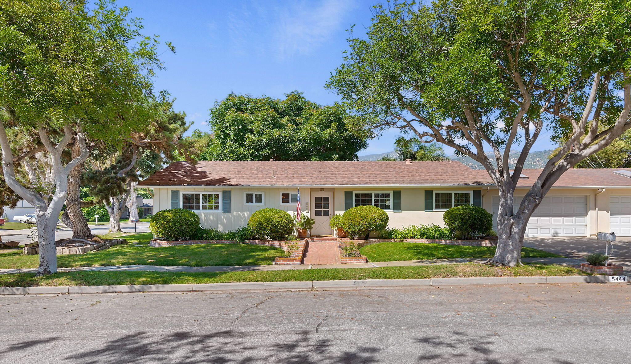 5444 Dariesa Street Carpinteria, CA 93013 - Photo 1 of 18 a front view of a house with a yard and potted plants