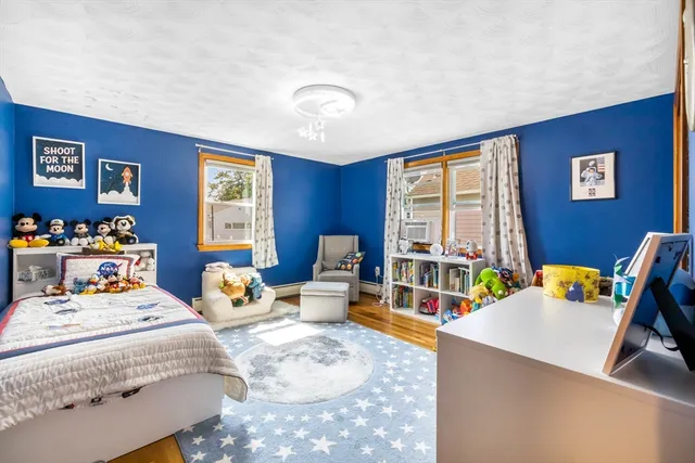 a bedroom with furniture and a large window