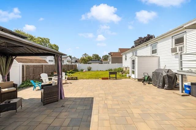 a view of a house with backyard porch and sitting area
