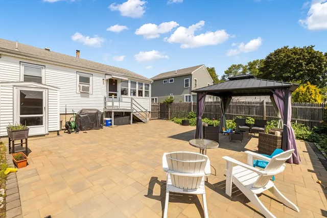 a view of a house with backyard sitting area and tub