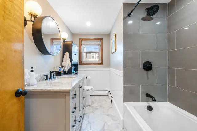 a bathroom with a sink a toilet and a mirror