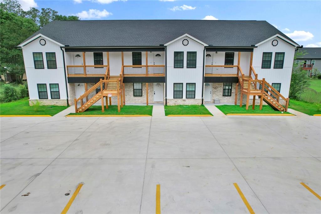 a front view of residential houses with yard