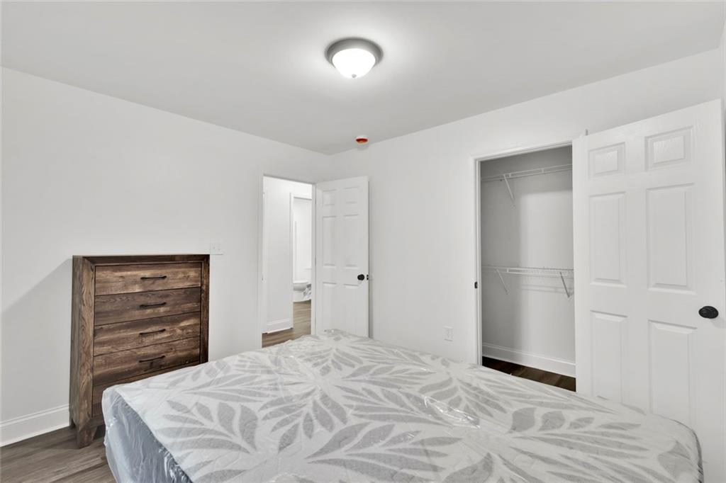 614 Elberta Street Fort Valley, GA 31030 - Photo 11 of 31 a bedroom with a bed and a dresser