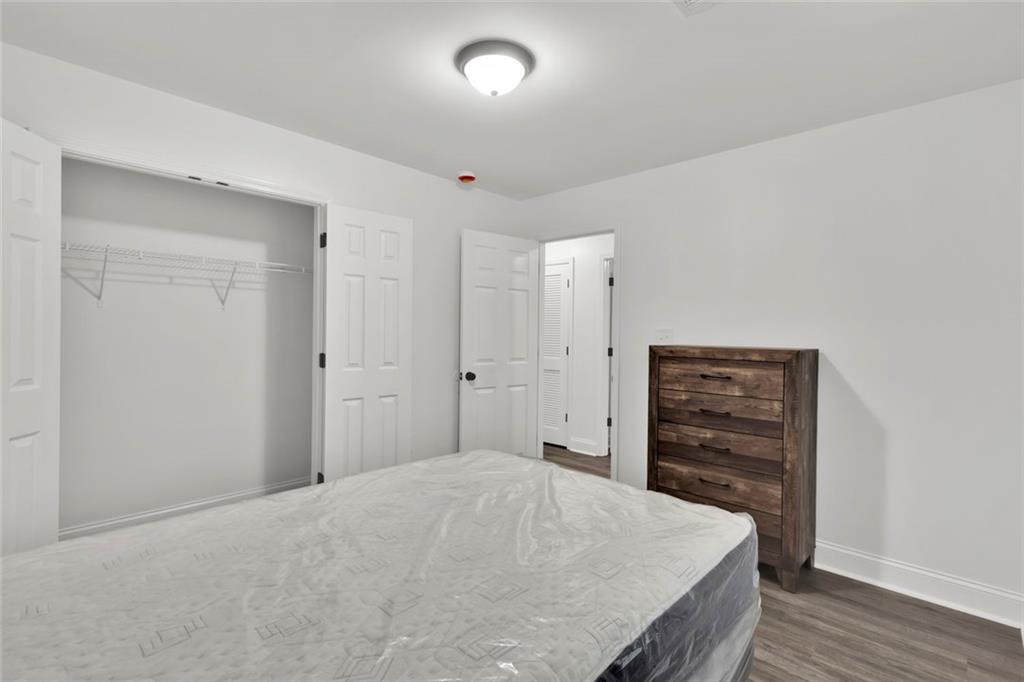 614 Elberta Street Fort Valley, GA 31030 - Photo 14 of 31 a bedroom with a bed and a dresser