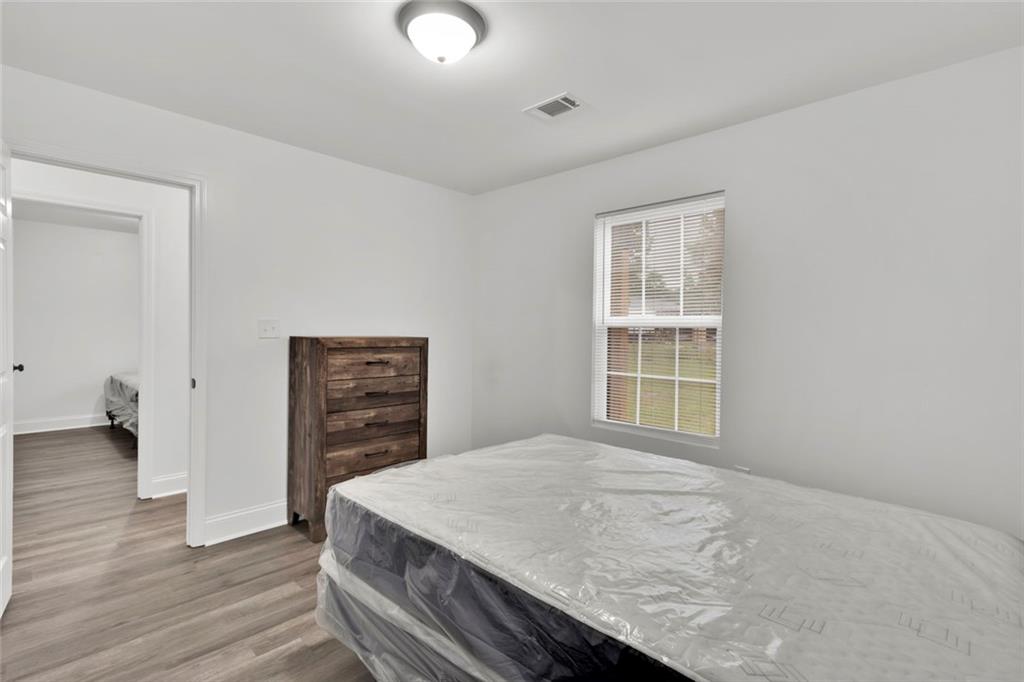 614 Elberta Street Fort Valley, GA 31030 - Photo 15 of 31 a bedroom with a bed and a dresser