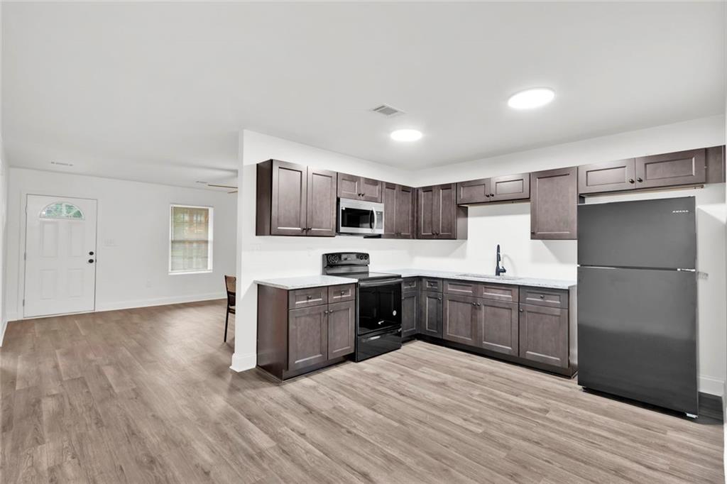 614 Elberta Street Fort Valley, GA 31030 - Photo 18 of 31 a kitchen with a refrigerator stove top oven and sink