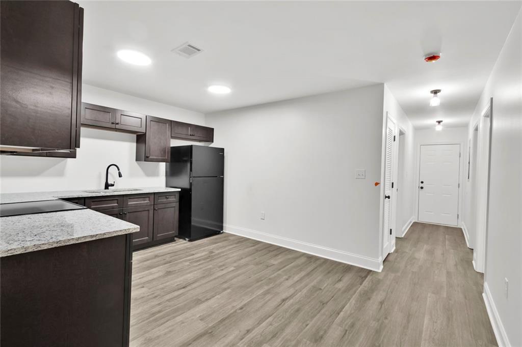 614 Elberta Street Fort Valley, GA 31030 - Photo 21 of 31 a kitchen with stainless steel appliances granite countertop a refrigerator and a sink