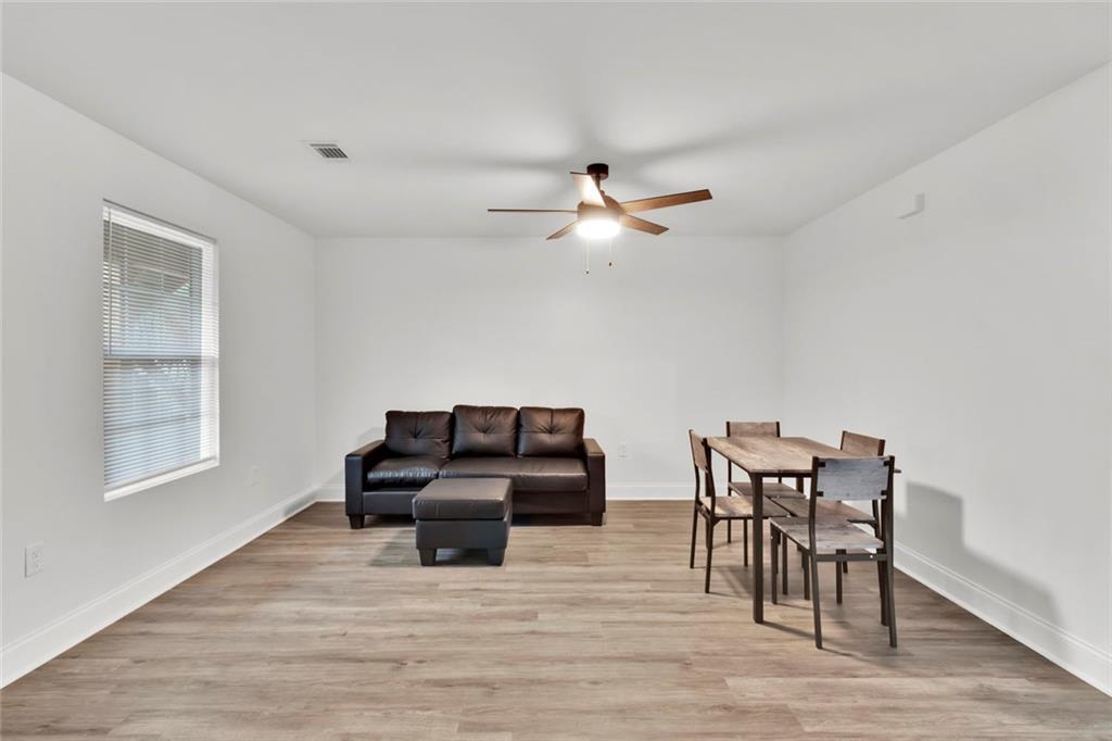 614 Elberta Street Fort Valley, GA 31030 - Photo 22 of 31 a living room with furniture and wooden floor