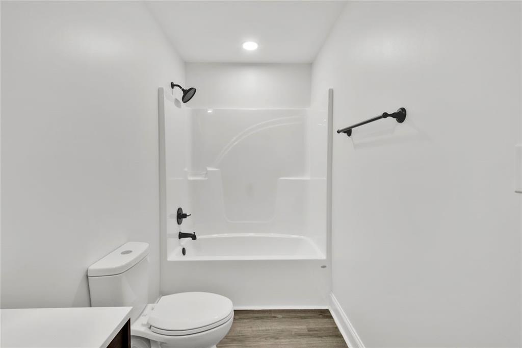 614 Elberta Street Fort Valley, GA 31030 - Photo 24 of 31 a bathroom with a toilet and a bath tub