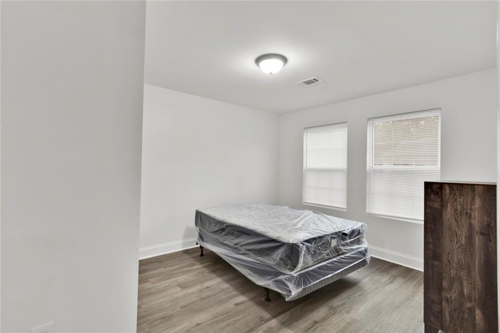 614 Elberta Street Fort Valley, GA 31030 - Photo 27 of 31 a bedroom with a bed and window