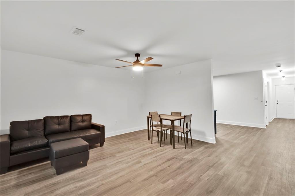 614 Elberta Street Fort Valley, GA 31030 - Photo 31 of 31 a living room with furniture and a wooden floor