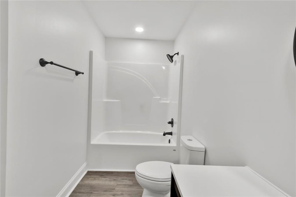 614 Elberta Street Fort Valley, GA 31030 - Photo 9 of 31 a bathroom with a toilet and shower