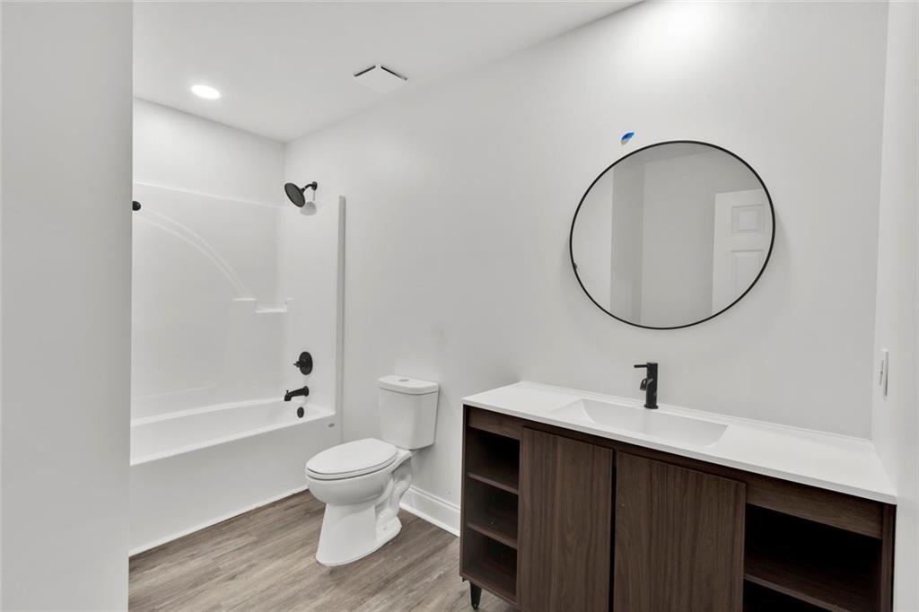 614 Elberta Street Fort Valley, GA 31030 - Photo 10 of 31 a bathroom with a sink a toilet and a mirror