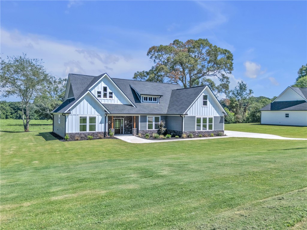 1725 Harris Bridge Road Anderson, SC 29621 - Photo 2 of 33 A graceful home featuring mixed materials and a neatly manicured lawn awaits new owners.