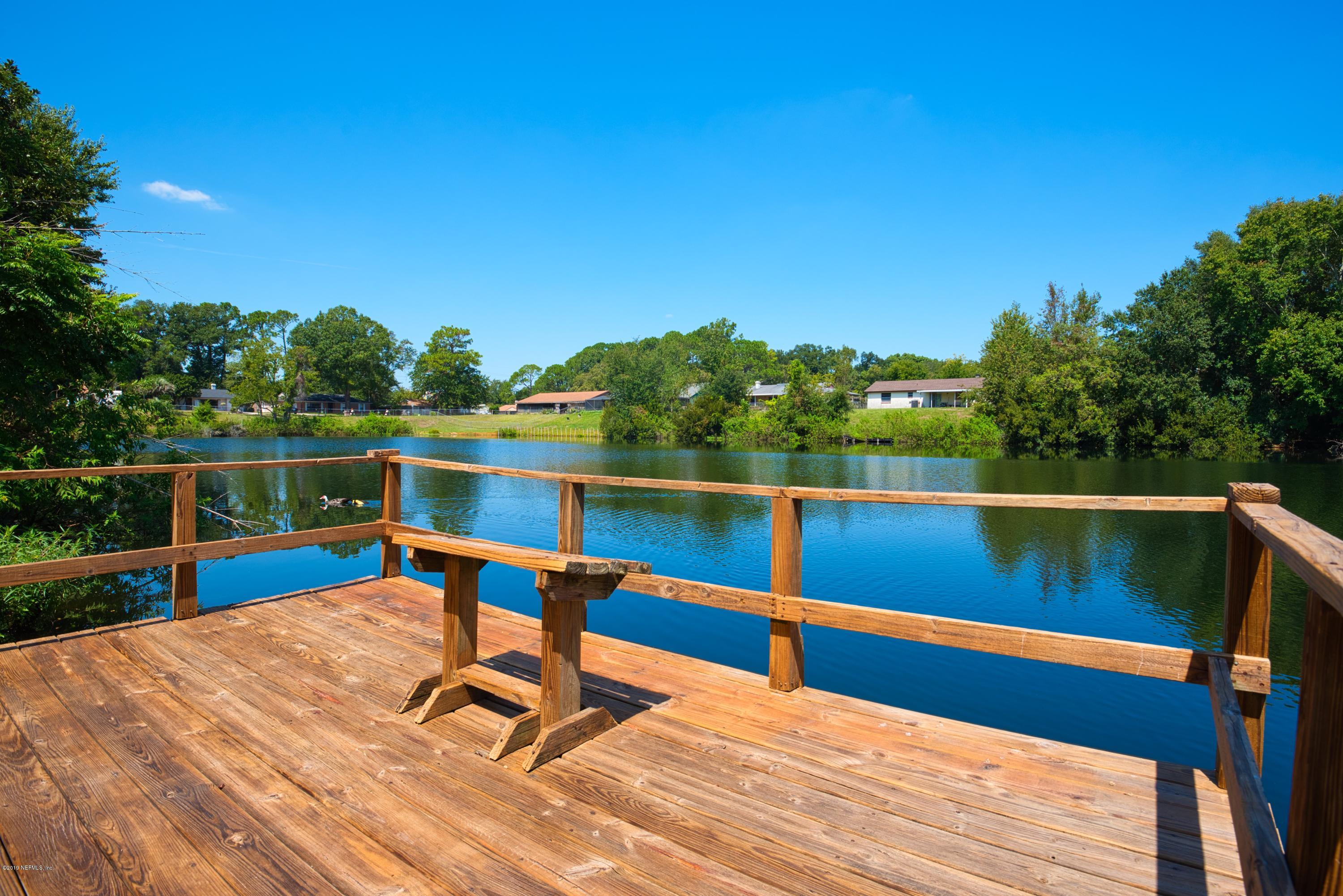 a view of wooden deck and a lake view