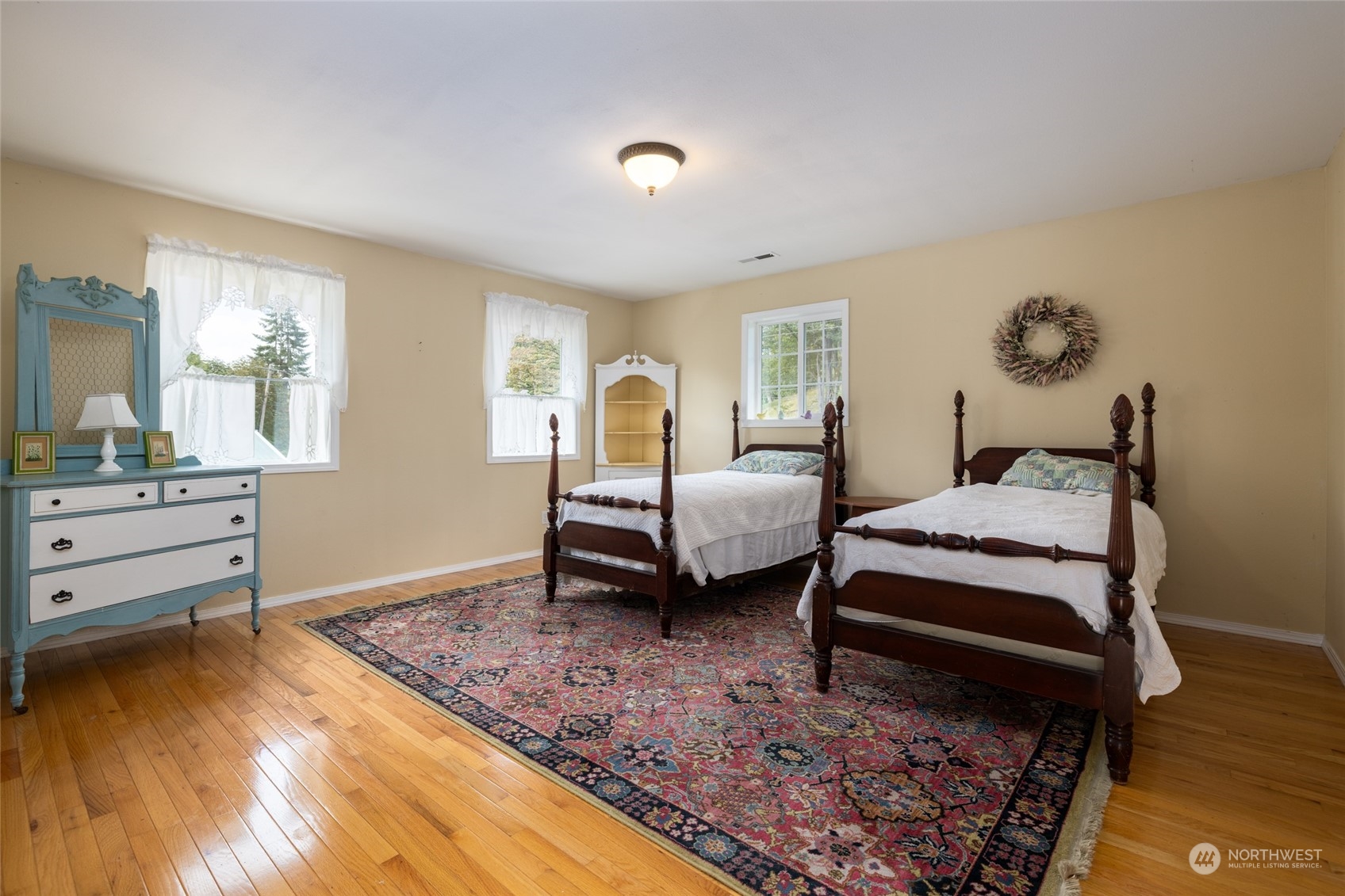 23610 Hoogdal Road Sedro-Woolley, WA 98284 - Photo 29 of 39 a spacious bedroom with a bed and wooden floor