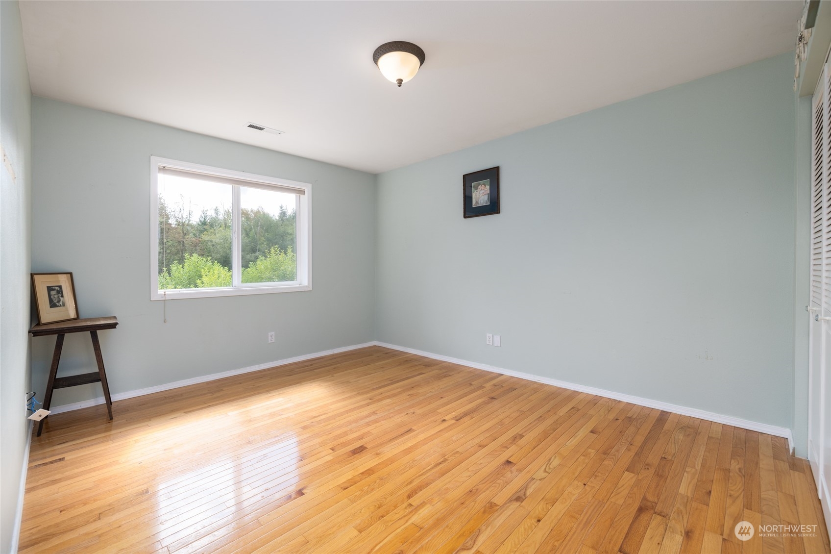 23610 Hoogdal Road Sedro-Woolley, WA 98284 - Photo 32 of 39 a view of an empty room with wooden floor and a window