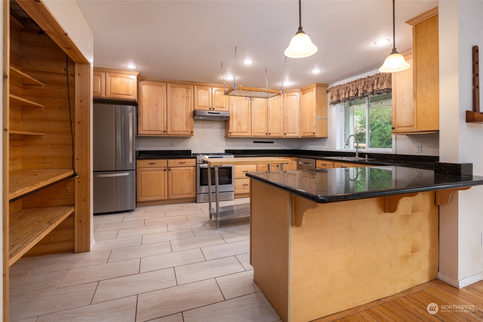 23610 Hoogdal Road Sedro-Woolley, WA 98284 - Photo 6 of 39 a kitchen with stainless steel appliances granite countertop a stove a sink a microwave and a refrigerator