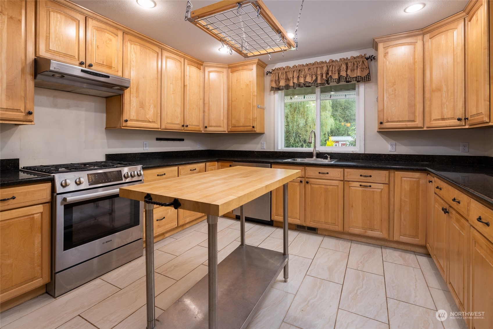 23610 Hoogdal Road Sedro-Woolley, WA 98284 - Photo 7 of 39 a kitchen with stainless steel appliances granite countertop a stove a sink and a microwave
