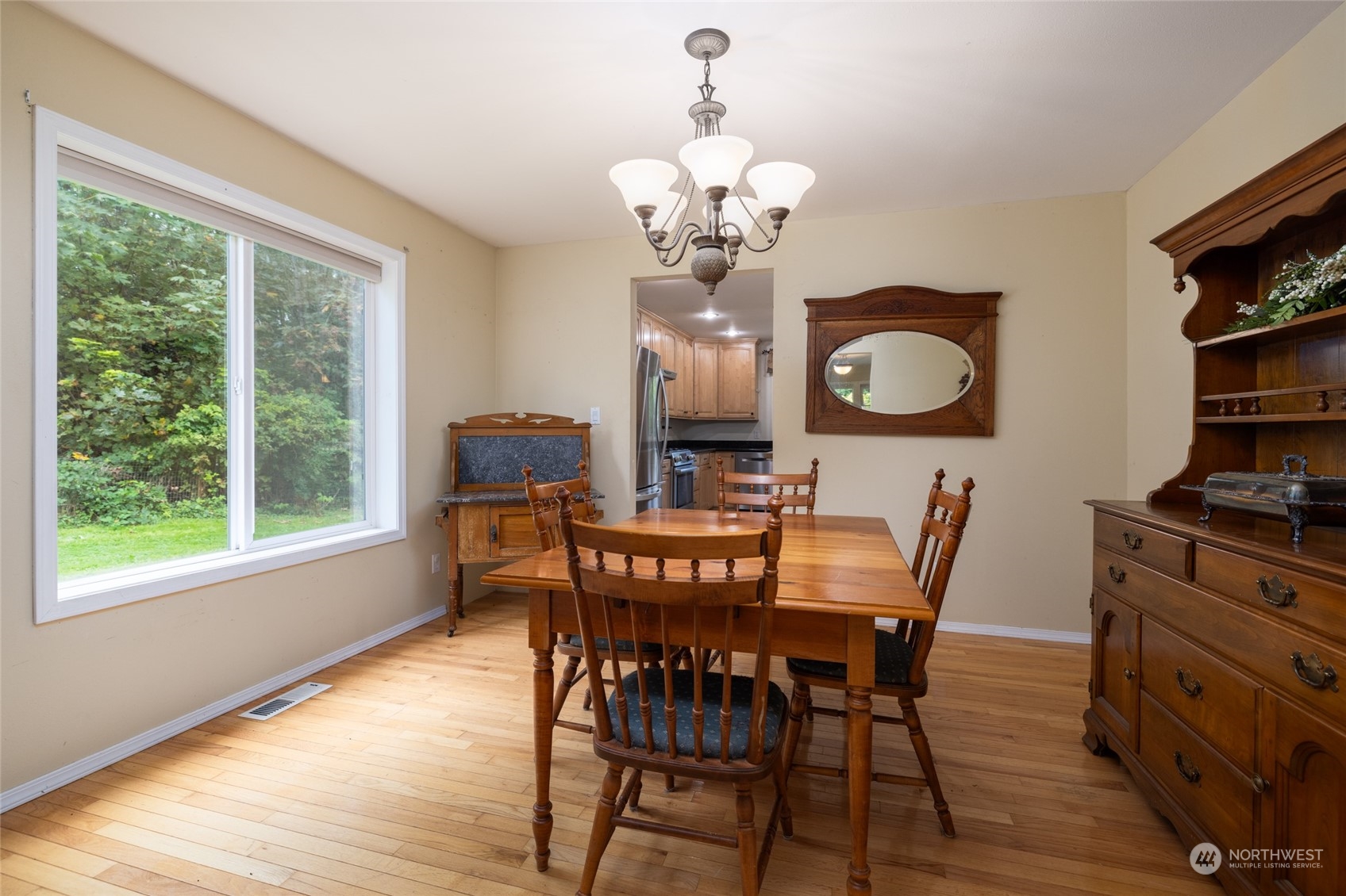 23610 Hoogdal Road Sedro-Woolley, WA 98284 - Photo 10 of 39 a view of a dining room with furniture a chandelier and wooden floor