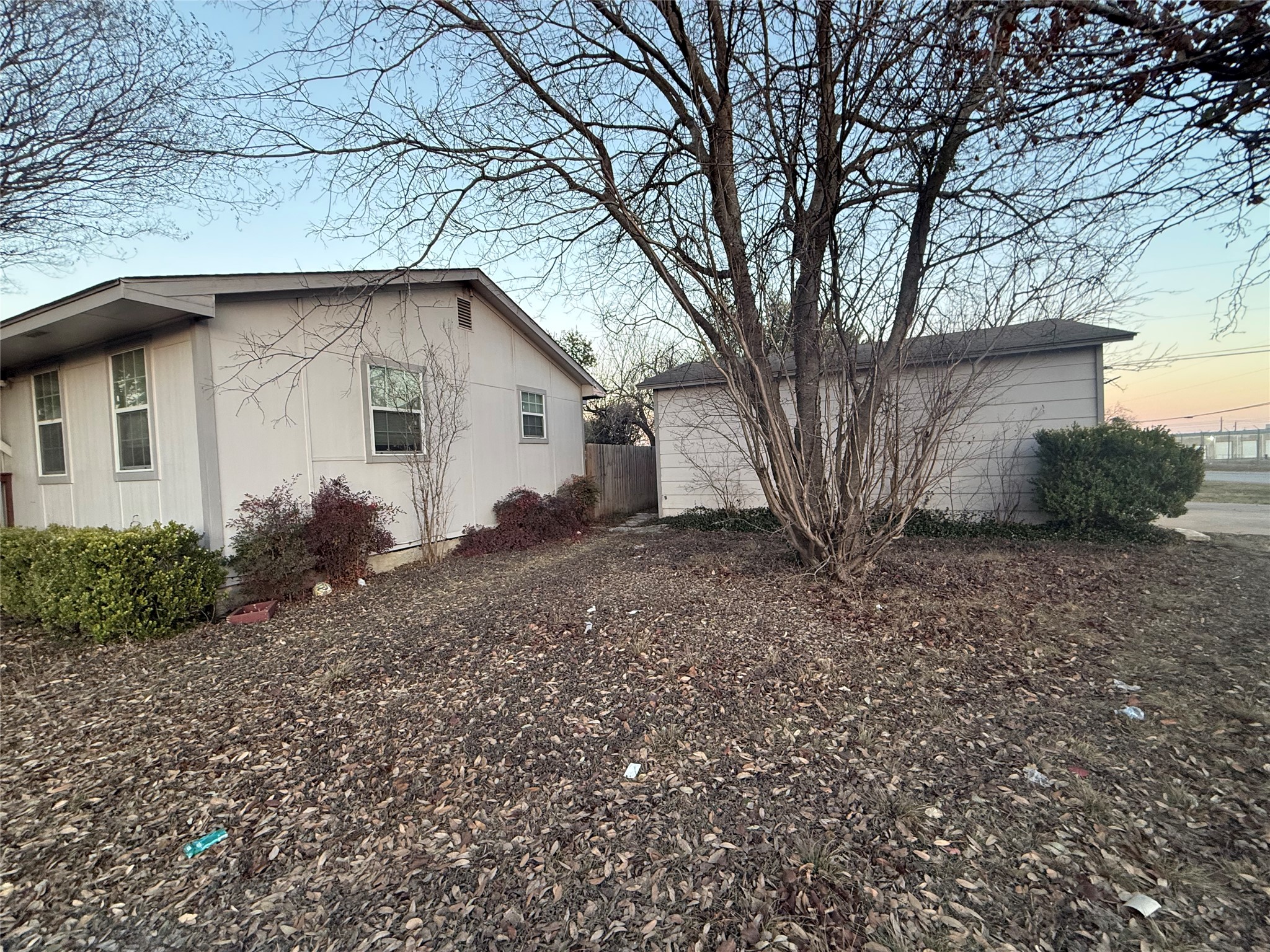 15501 Connie Street Austin, TX 78728 - Photo 16 of 26 Property exterior at dusk featuring an outbuilding