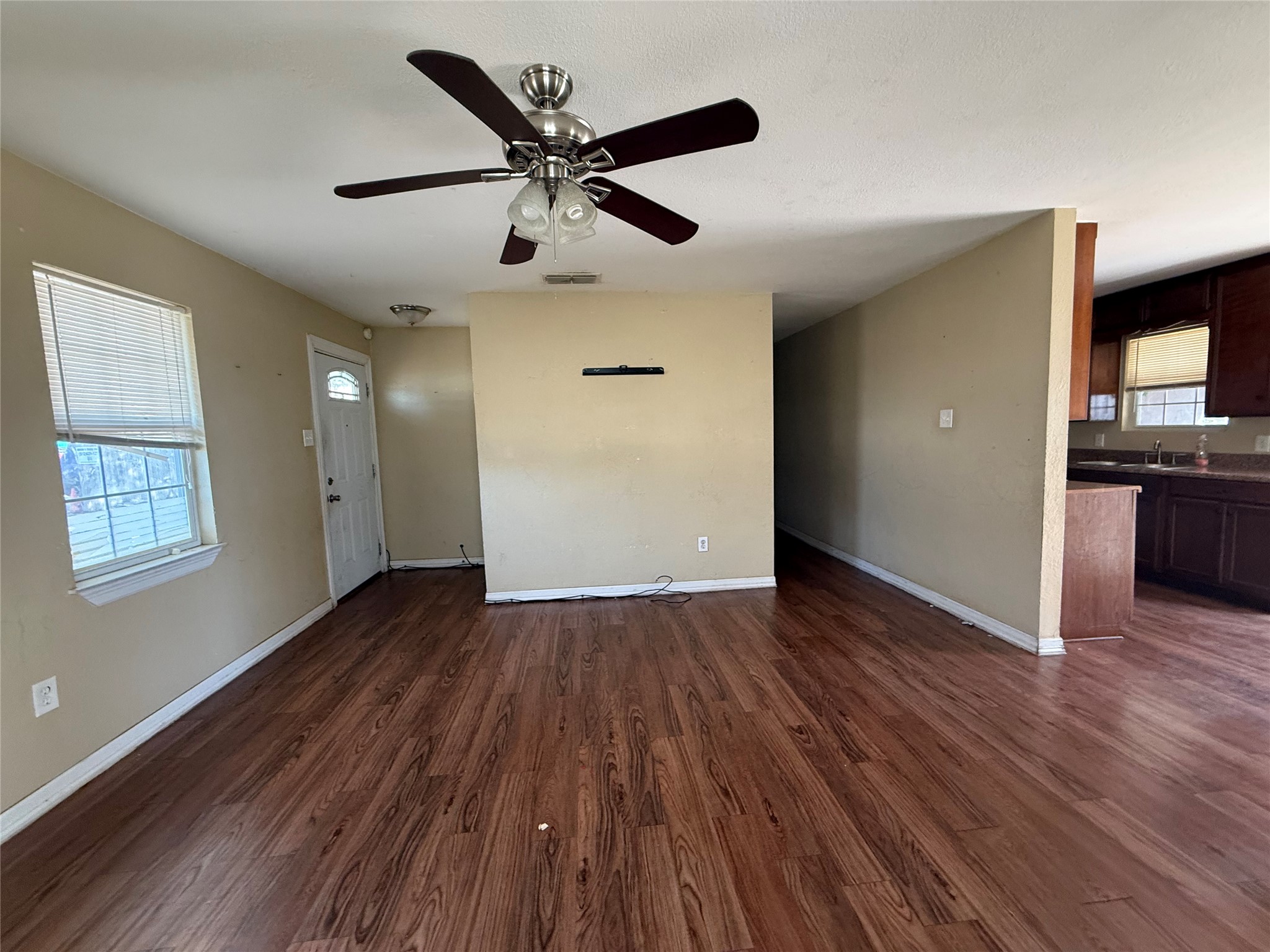 15501 Connie Street Austin, TX 78728 - Photo 10 of 26 Unfurnished living room with dark wood-type flooring and a ceiling fan