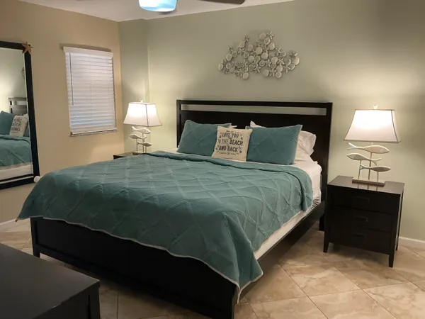 a bedroom with a bed and a lamp