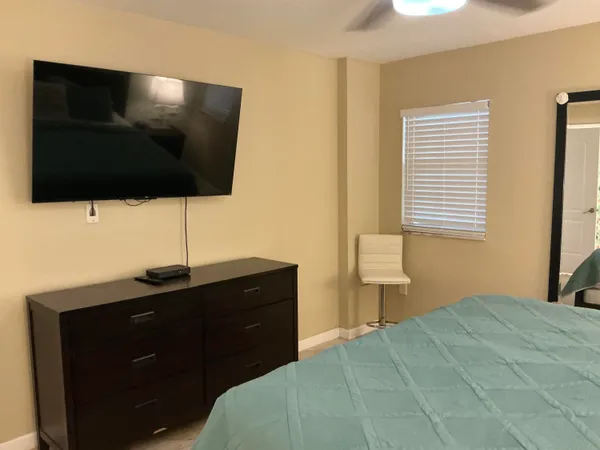 a bedroom with a bed and a flat screen tv