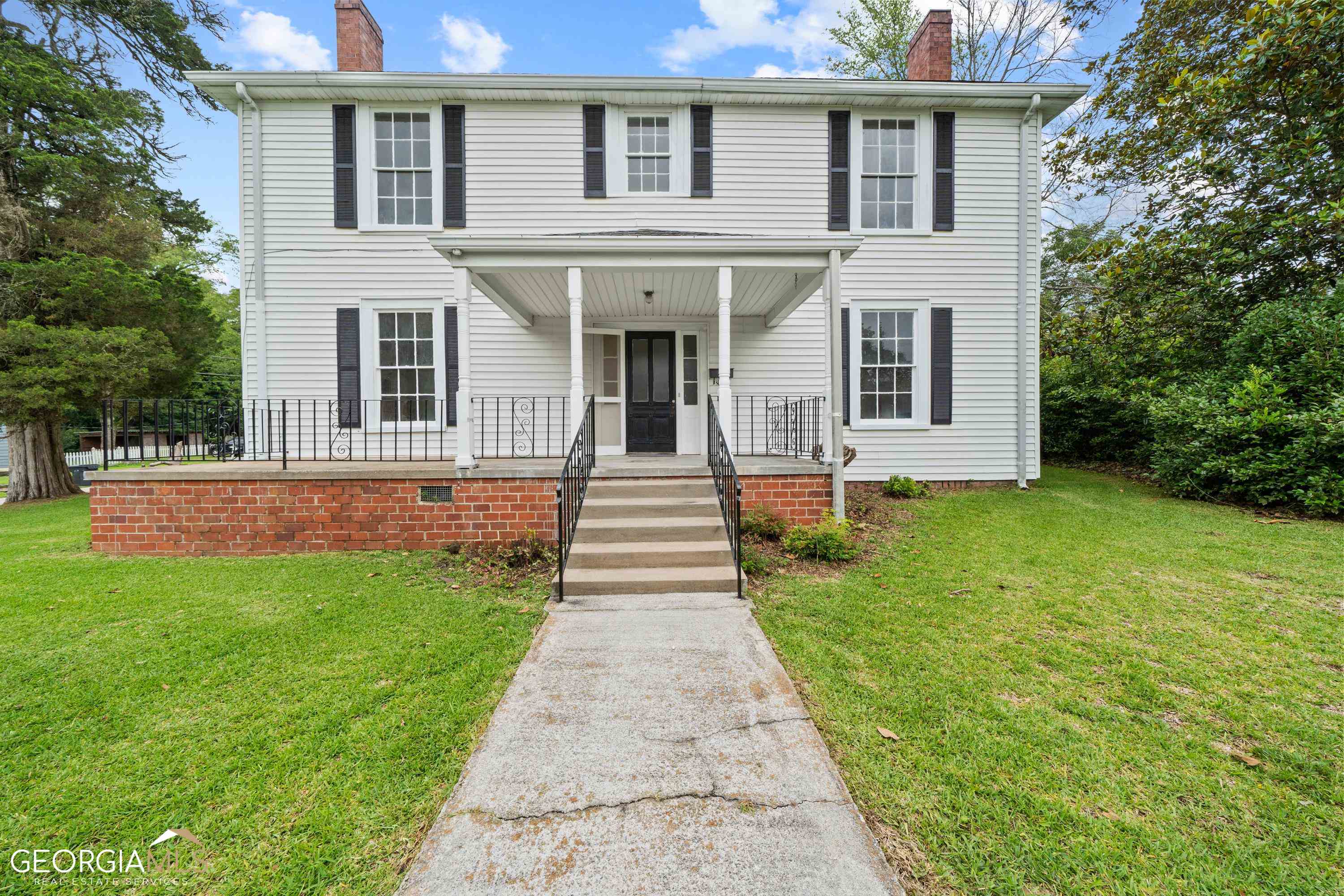 202 Veazey Street Union Point, GA 30669 - Photo 1 of 1 a front view of a house with garden