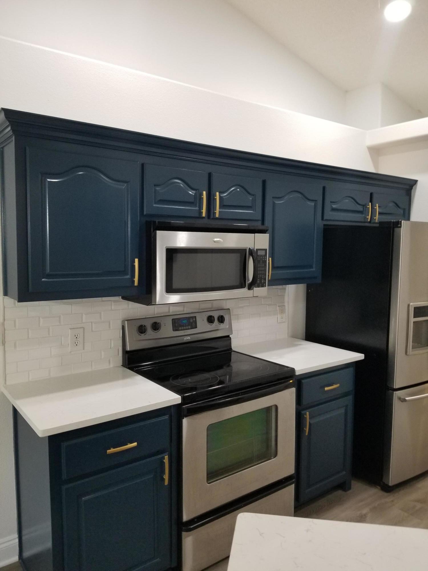 6673 Redfield Street Navarre, FL 32566 - Photo 12 of 32 a kitchen with a stove and a microwave