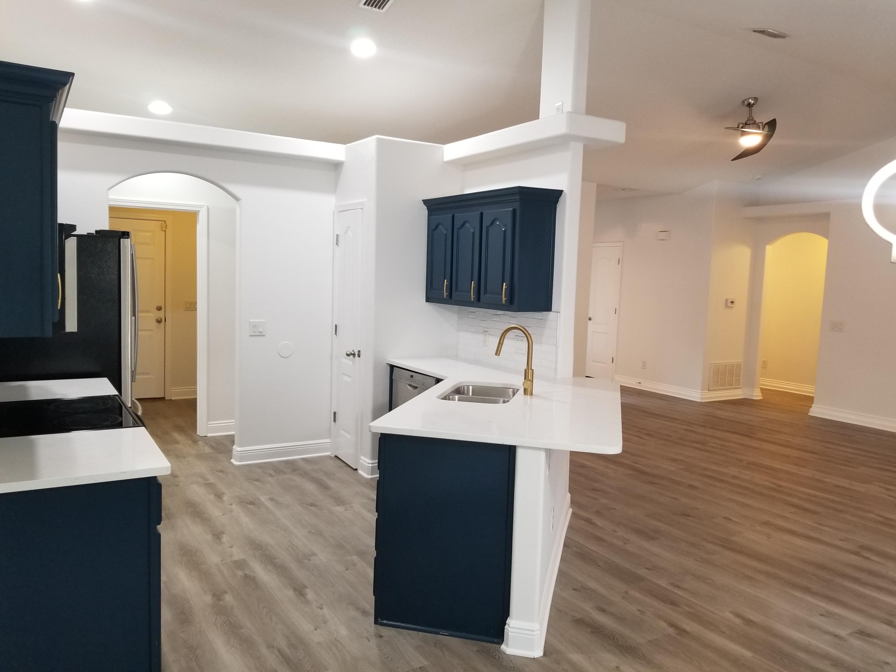 6673 Redfield Street Navarre, FL 32566 - Photo 13 of 32 a view of a sink and mirror with wooden floor