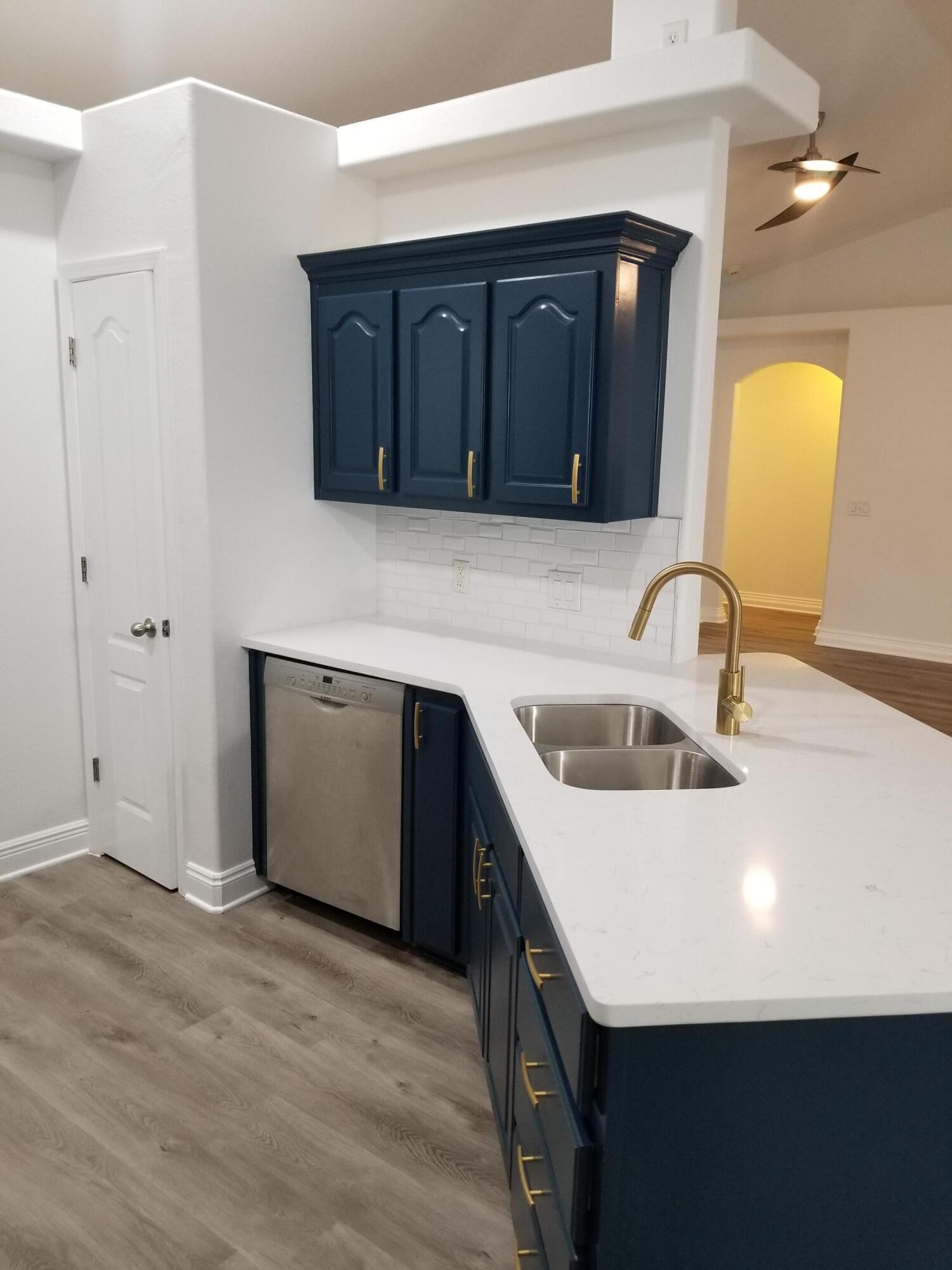 6673 Redfield Street Navarre, FL 32566 - Photo 14 of 32 a kitchen with a sink and a refrigerator