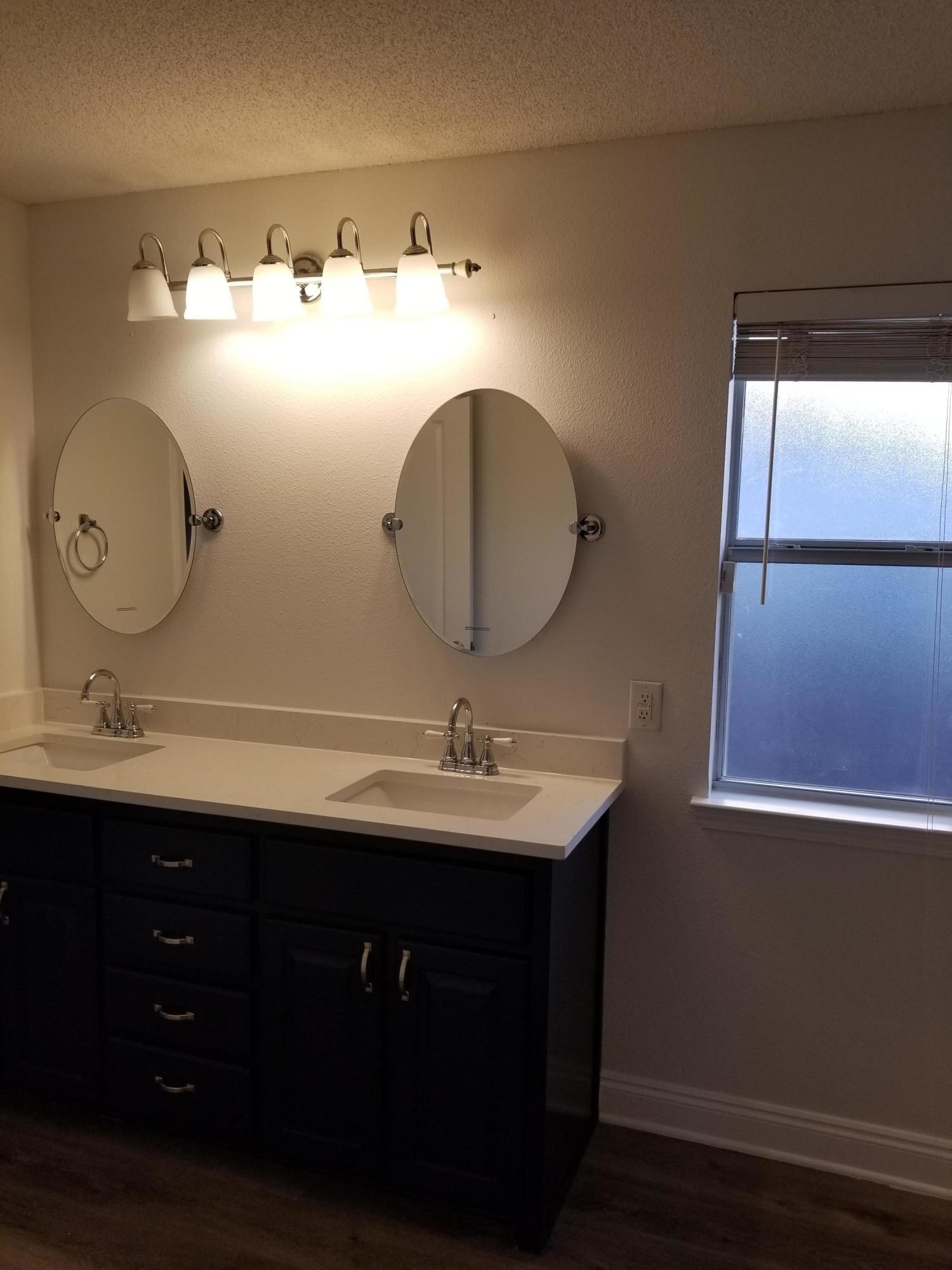 6673 Redfield Street Navarre, FL 32566 - Photo 20 of 32 a bathroom with a sink and a mirror
