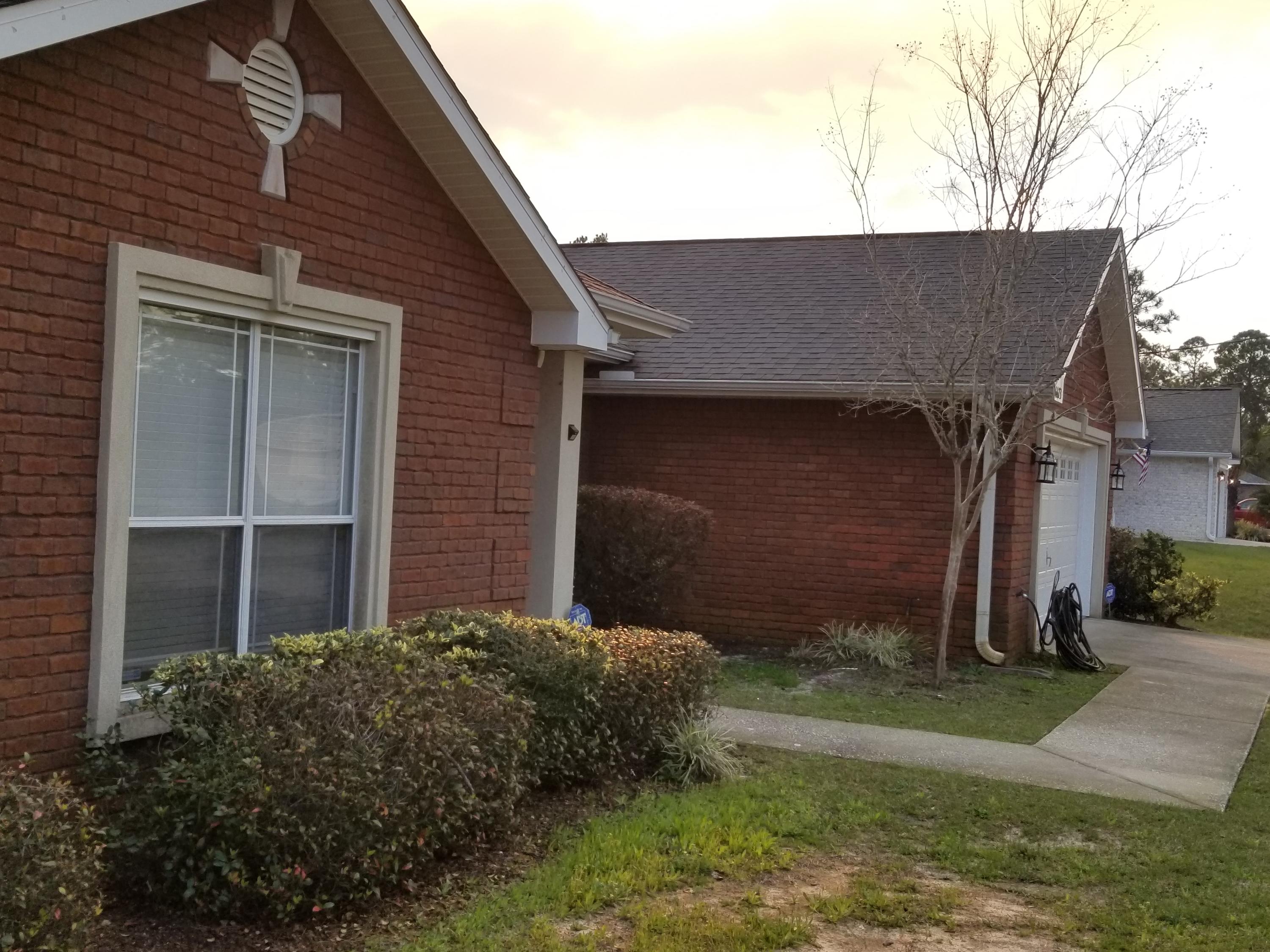 6673 Redfield Street Navarre, FL 32566 - Photo 2 of 32 a backyard of a house