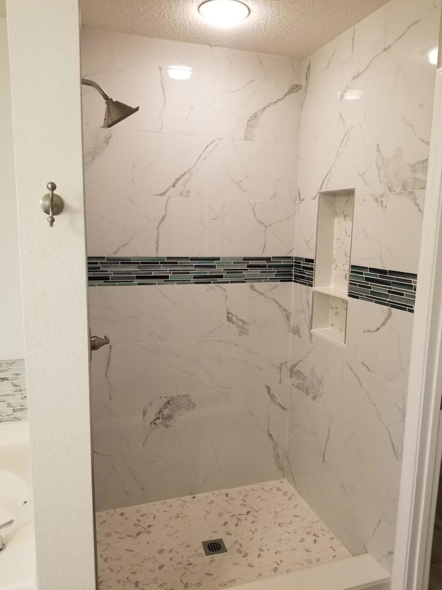 6673 Redfield Street Navarre, FL 32566 - Photo 22 of 32 a bathroom with a shower
