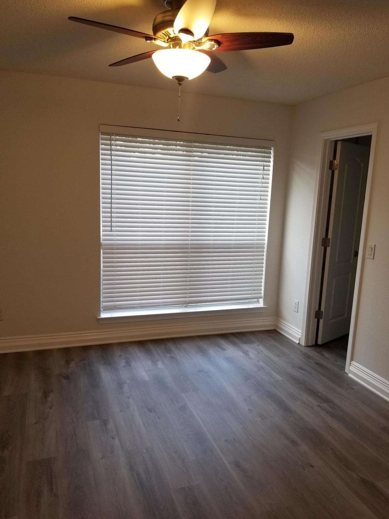 6673 Redfield Street Navarre, FL 32566 - Photo 23 of 32 a view of an empty room with wooden floor and a window